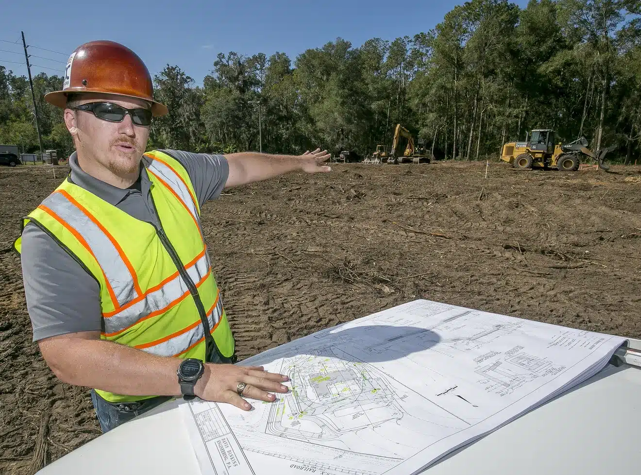 Ron Henion looking at a set of plans
